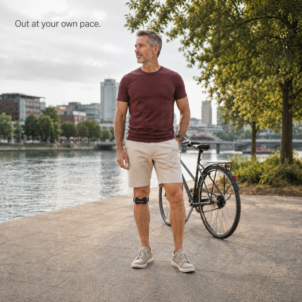 Man wearing the Kynova strap beside a bicycle